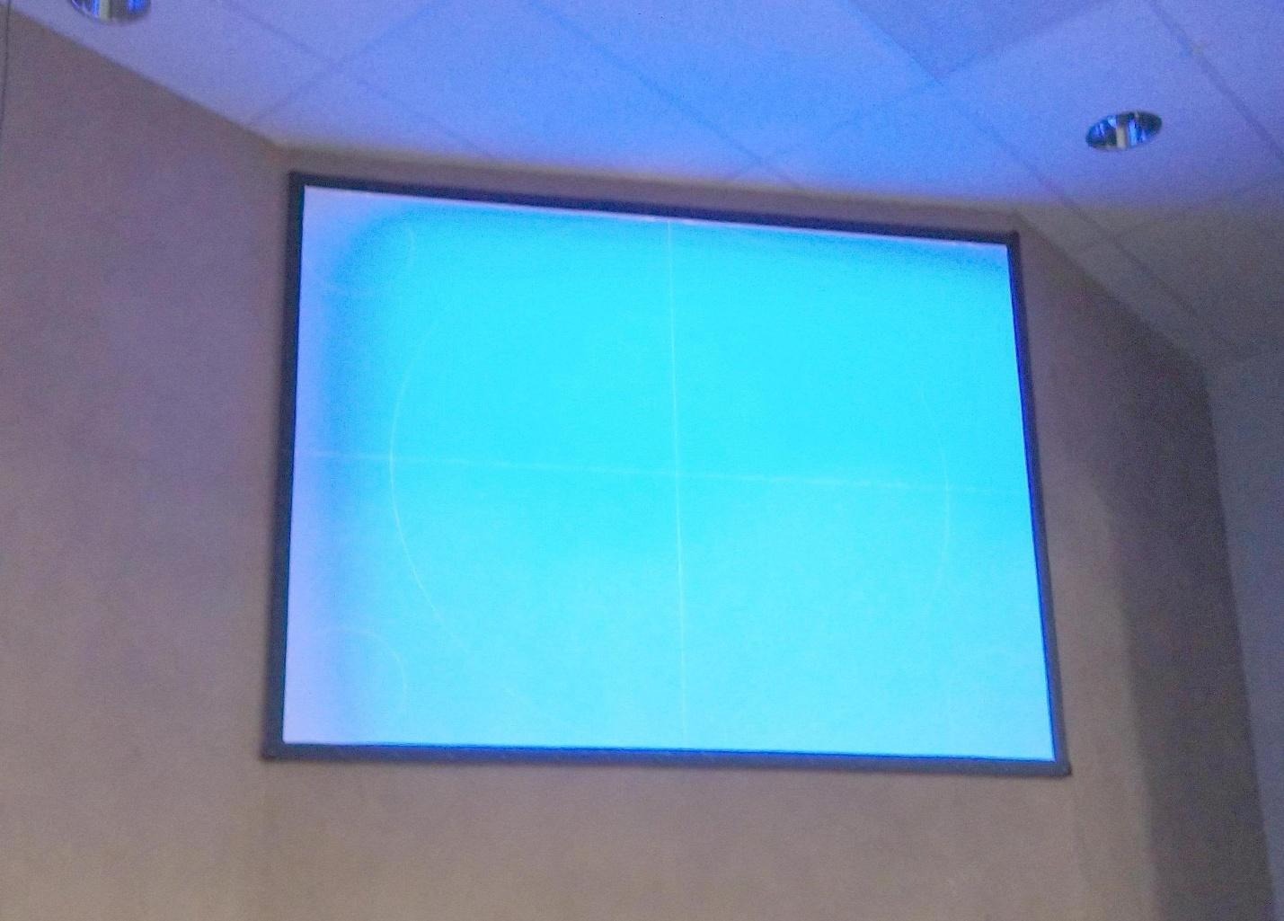 Projector screen burn showing blue discoloration on a projected image
