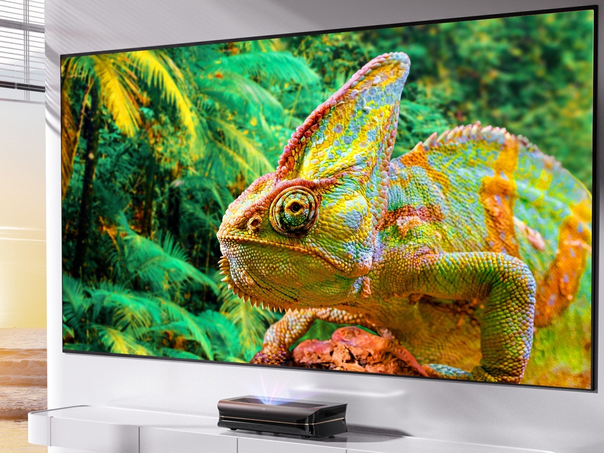 A close-up of a vibrant, multi-colored chameleon on a large projector screen, demonstrating the stunning color and detail provided by high-quality HDR.