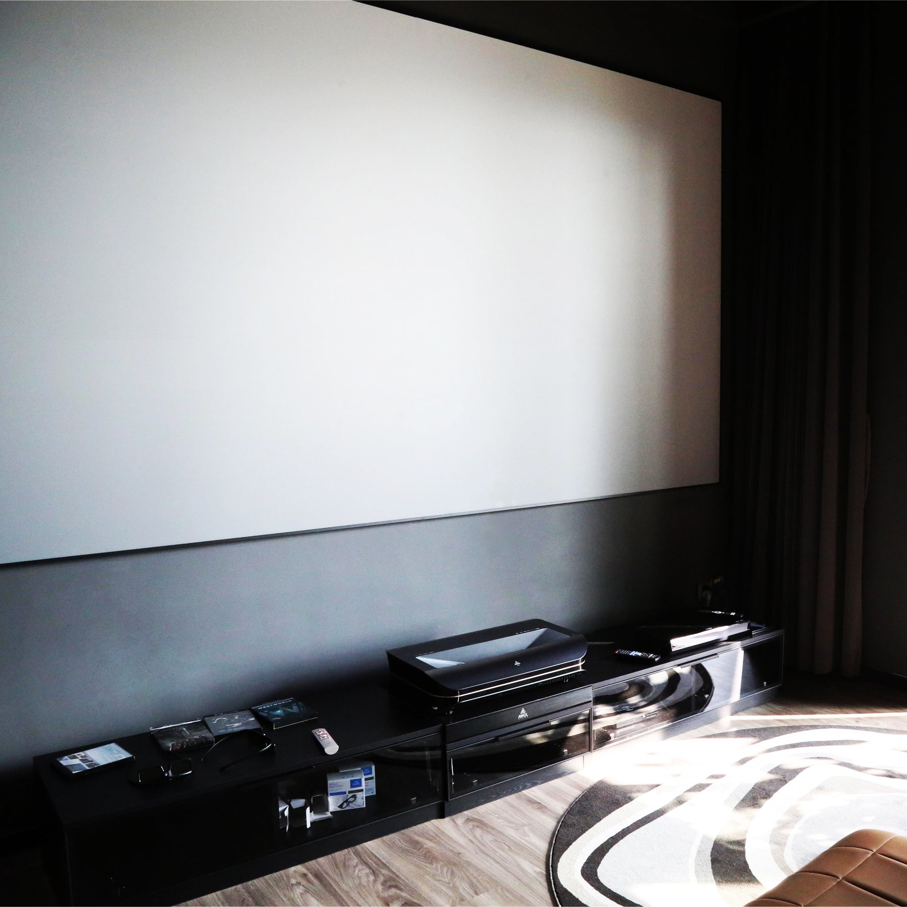 100-150 inch Lenticular ALR Fixed Frame Projector Screen blank surface in modern living room.
