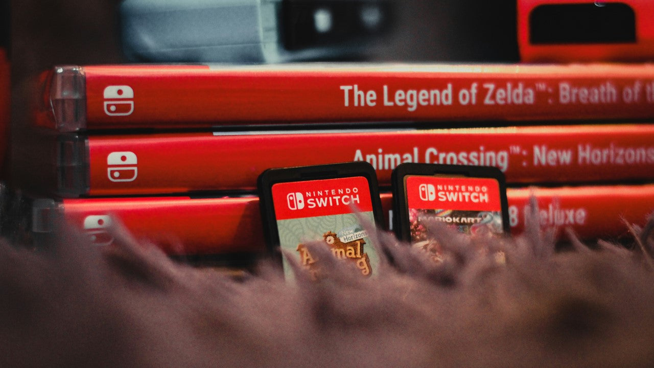 Close-up of Nintendo Switch cartridges and boxes, referencing the best party games for Switch.