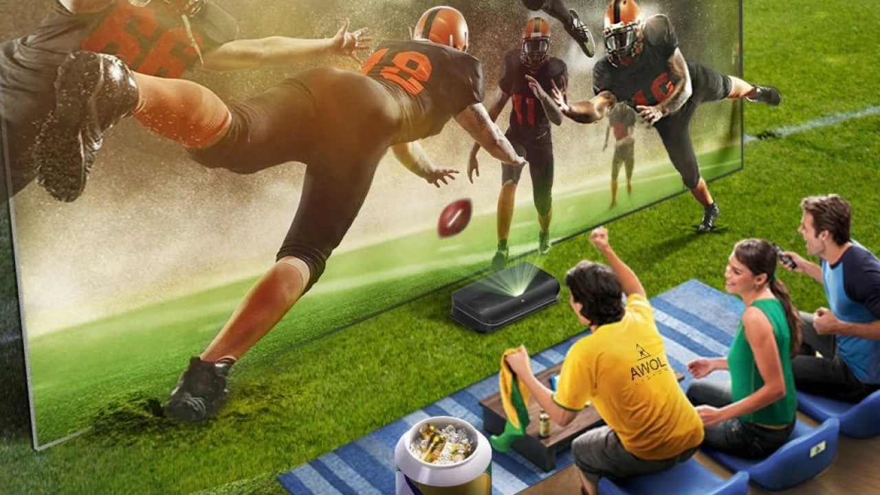 Fans enjoying a football game using the best projector for watching sports at home.