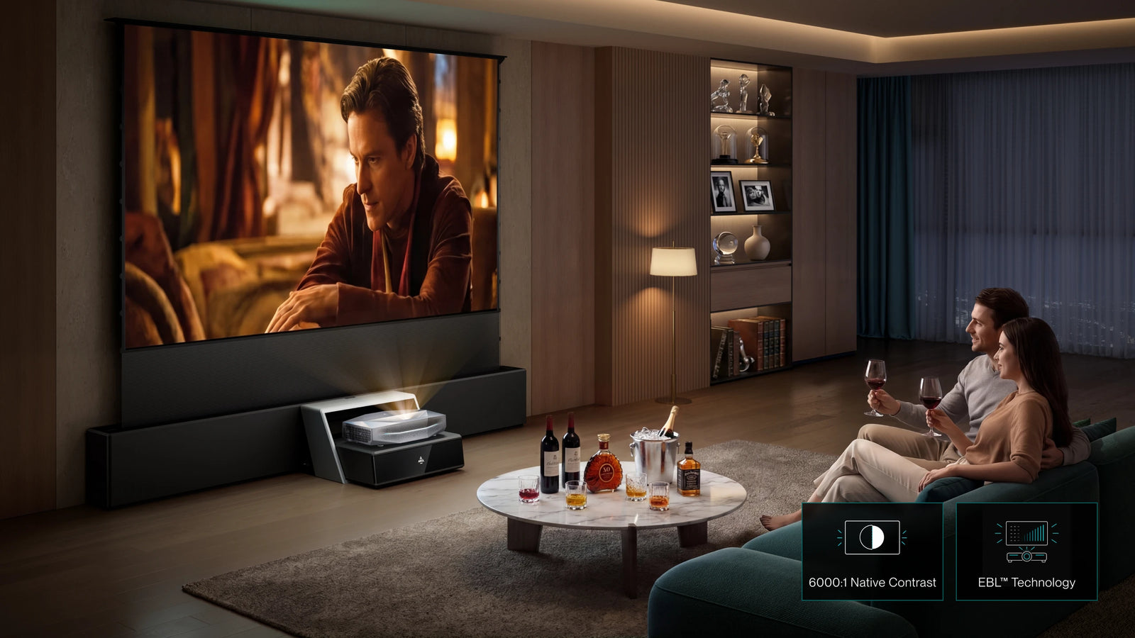 Couple watching a movie on an AWOL Vision living room projector setup with a large cinematic screen.