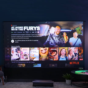 4K 3D Triple Laser Projector LTV-3500 Pro displaying Netflix's interface featuring "At Home with the Furys", showing vivid colors and sharp detail in a home theater setting.